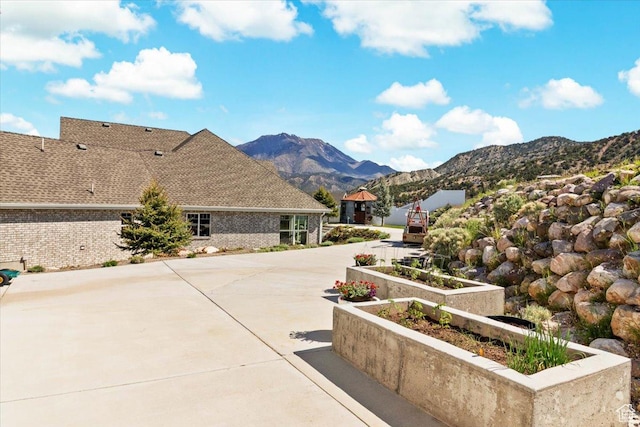 view of home's community featuring a mountain view and a patio area