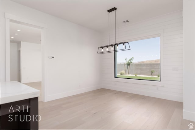 657 E Royal Dr, Washington, UT 84780 - unfurnished dining area featuring light wood-type flooring, a chandelier, and baseboards