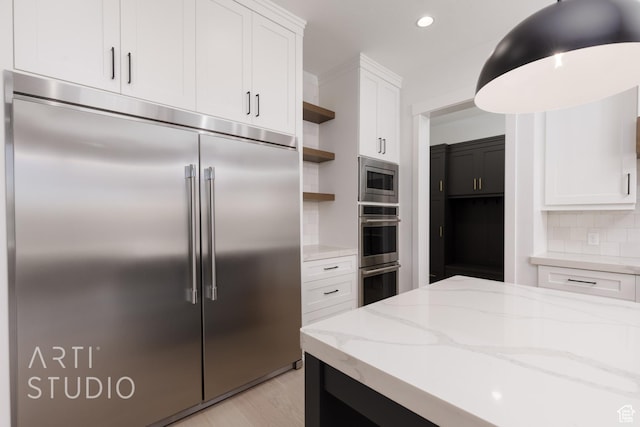 657 E Royal Dr, Washington, UT 84780 - kitchen with built in appliances, open shelves, white cabinets, backsplash, and light stone countertops