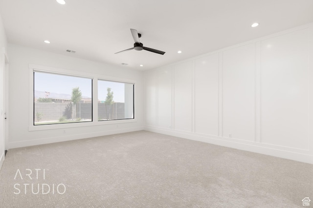 657 E Royal Dr, Washington, UT 84780 - empty room with light colored carpet, a ceiling fan, recessed lighting, a decorative wall, and baseboards