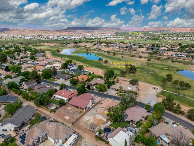 aerial perspective of suburban area featuring a water and mountain view and a golf course