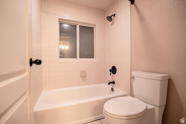 bathroom featuring toilet and  shower combination
