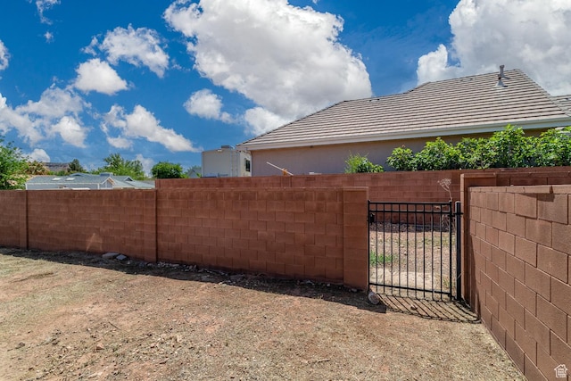 view of yard with fence and a gate