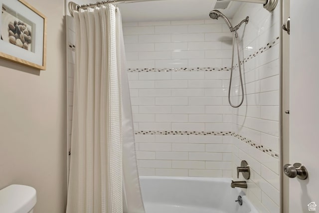 bathroom with toilet and shower / tub combo