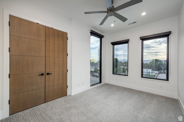 9969 S Altamont Dr E, Sandy, UT 84092 - unfurnished bedroom featuring multiple windows, light colored carpet, recessed lighting, baseboards, and ceiling fan