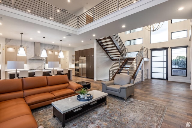 9969 S Altamont Dr E, Sandy, UT 84092 - living room featuring a towering ceiling, stairway, recessed lighting, dark wood-style flooring, and a chandelier