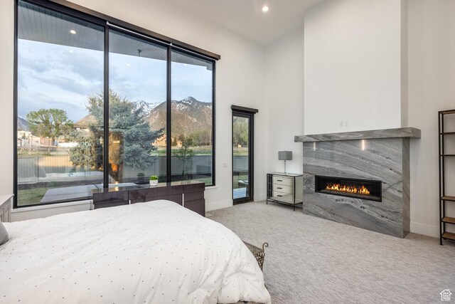 9969 S Altamont Dr E, Sandy, UT 84092 - bedroom featuring carpet floors, a glass covered fireplace, baseboards, and access to outside