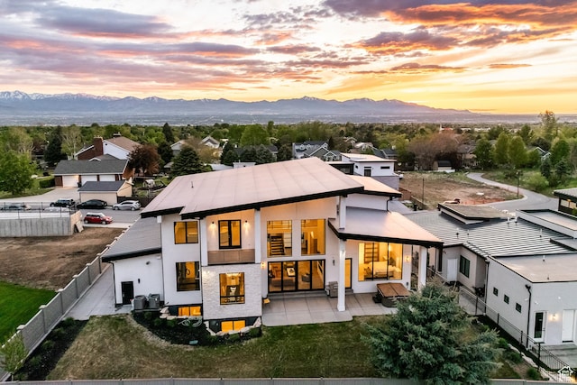 9969 S Altamont Dr E, Sandy, UT 84092 - back of property featuring a mountain view, a fenced backyard, stucco siding, and a patio area