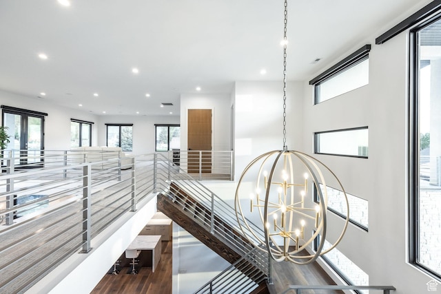 9969 S Altamont Dr E, Sandy, UT 84092 - hallway featuring a chandelier, recessed lighting, wood finished floors, and healthy amount of natural light