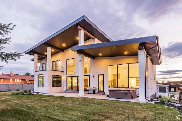 9969 S Altamont Dr E, Sandy, UT 84092 - back of house featuring a hot tub, a balcony, a patio, and stucco siding