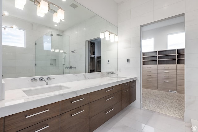9969 S Altamont Dr E, Sandy, UT 84092 - full bath with a stall shower, plenty of natural light, double vanity, tile walls, and tile patterned floors