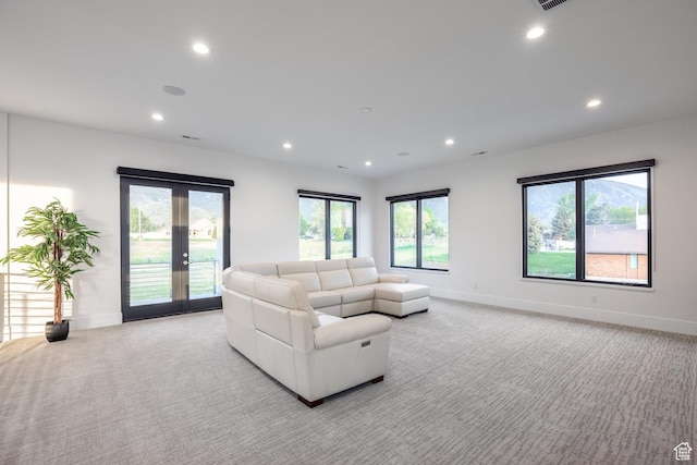 9969 S Altamont Dr E, Sandy, UT 84092 - living area with light colored carpet, recessed lighting, baseboards, french doors, and plenty of natural light