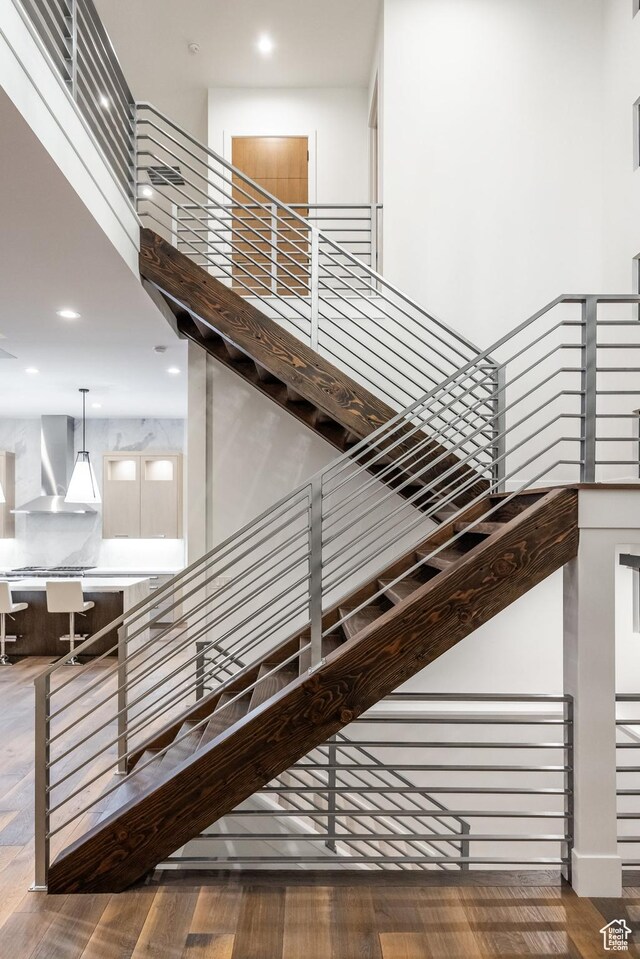 9969 S Altamont Dr E, Sandy, UT 84092 - staircase featuring wood finished floors, recessed lighting, and a towering ceiling