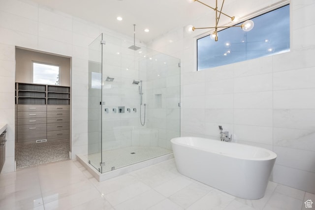 9969 S Altamont Dr E, Sandy, UT 84092 - bathroom with tile walls, a stall shower, a freestanding bath, healthy amount of natural light, and vanity