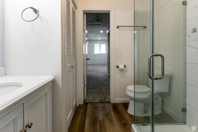 1950 S 200 W Unit B12, Bountiful, UT 84010 - full bathroom featuring wood finished floors, a shower stall, vanity, and toilet