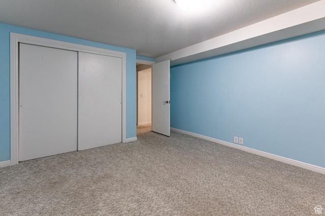 1950 S 200 W Unit B12, Bountiful, UT 84010 - unfurnished bedroom featuring carpet flooring, baseboards, a textured ceiling, and a closet