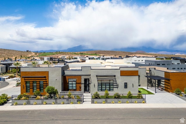 view of front of home with stucco siding and a mountain view