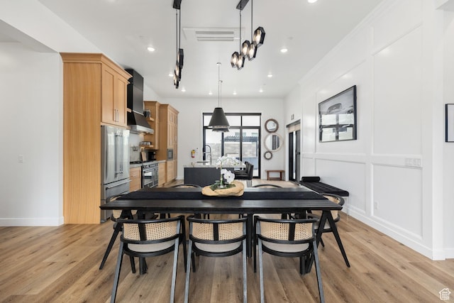 1450 W Torrey Pines Rd, Hurricane, UT 84737 - dining space with light wood finished floors, recessed lighting, and a decorative wall