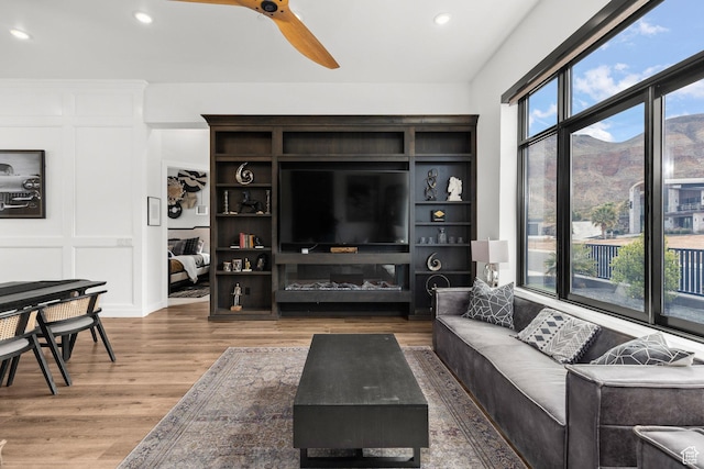 living room featuring wood finished floors, ceiling fan, and recessed lighting