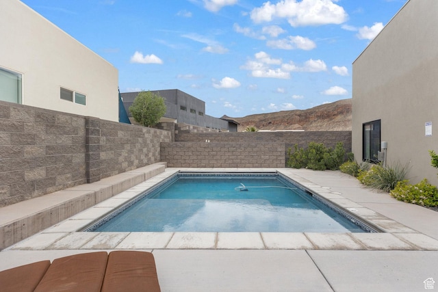 view of pool with a fenced backyard