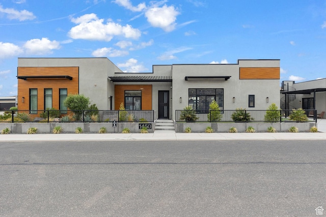 contemporary house with stucco siding and fence