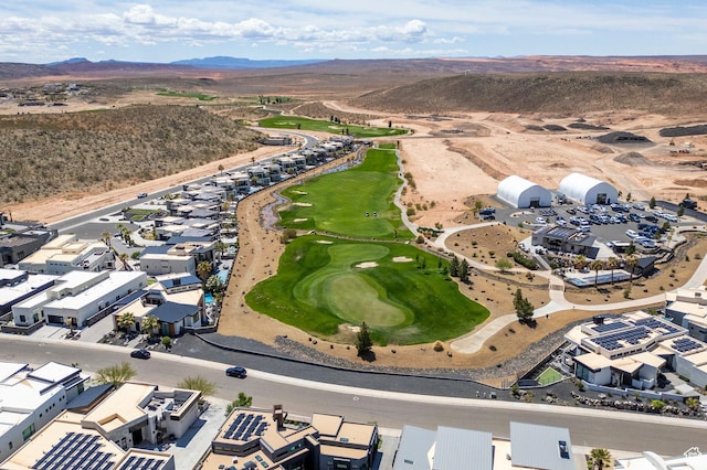 bird's eye view of mountains and a golf club