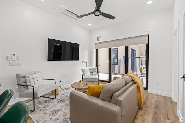 living room featuring a ceiling fan, recessed lighting, light wood-style floors, and baseboards