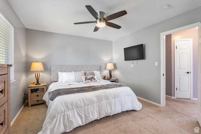 carpeted bedroom with baseboards and a ceiling fan