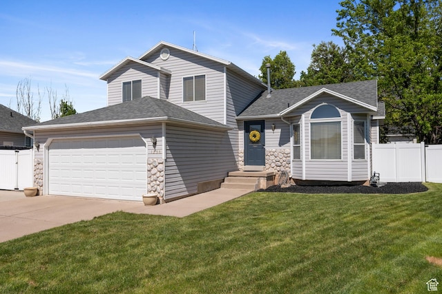 tri-level home featuring concrete driveway, a garage, a shingled roof, and stone siding