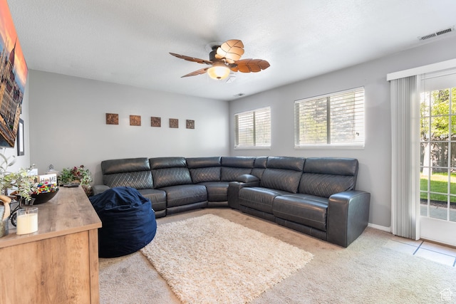 carpeted living room featuring a ceiling fan