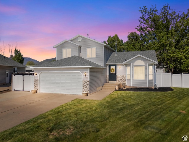 view of front of property with a garage, driveway, stone siding, roof with shingles, and a gate