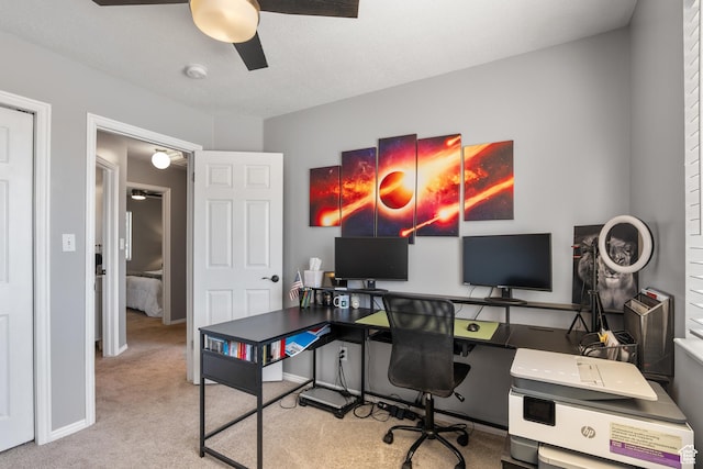 carpeted office featuring ceiling fan