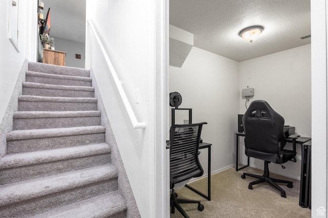 office with carpet, a textured ceiling, and baseboards