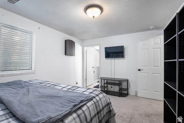 carpeted bedroom featuring a textured ceiling