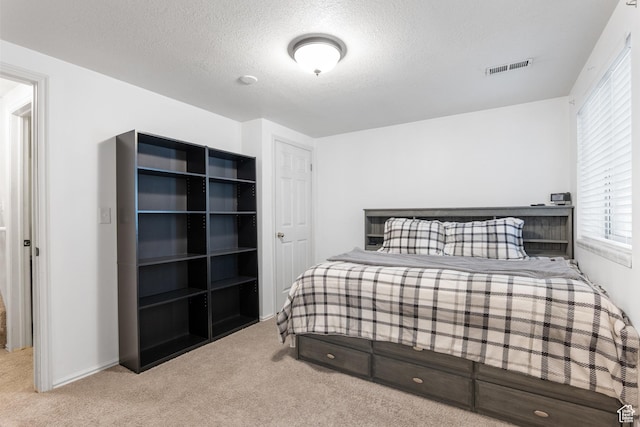 carpeted bedroom with a textured ceiling