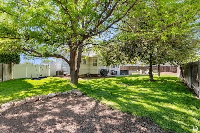 view of yard featuring central air condition unit and a patio area