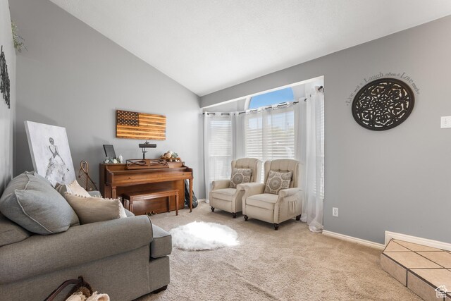 living room featuring light colored carpet, baseboards, and high vaulted ceiling