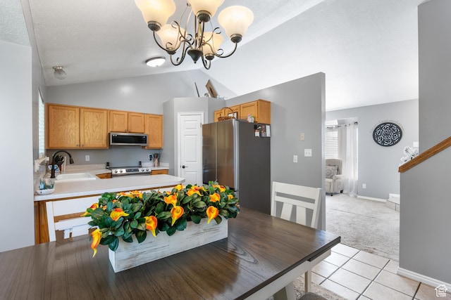 dining space with vaulted ceiling, a chandelier, light carpet, light tile patterned flooring, and baseboards