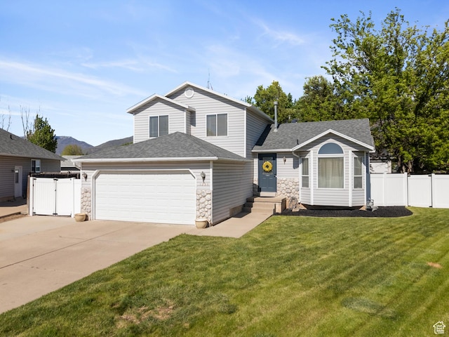 tri-level home with an attached garage, driveway, a shingled roof, and stone siding