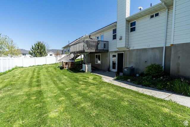 rear view of house featuring a wooden deck, stairs, a chimney, and central air condition unit
