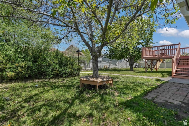 view of yard with stairs and a deck