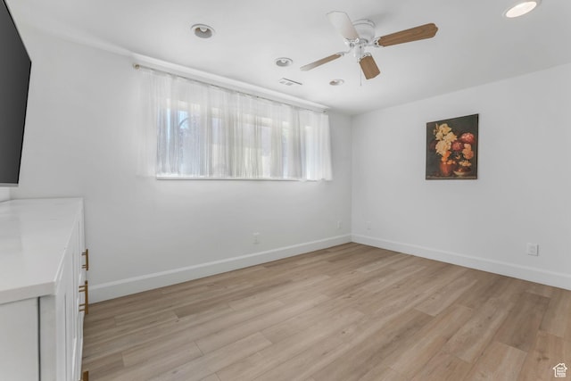 empty room with ceiling fan, light wood-style floors, baseboards, and recessed lighting