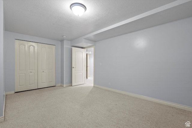 5280 S 1035 E, South Ogden, UT 84403 - unfurnished bedroom with baseboards, a textured ceiling, carpet, and a closet
