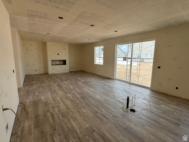 unfurnished living room with wood finished floors and a fireplace