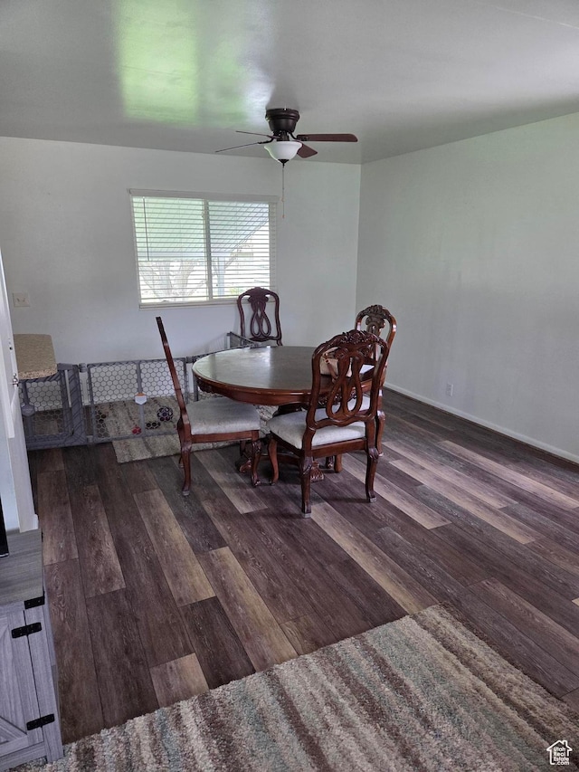dining area featuring a ceiling fan, wood finished floors, and baseboards