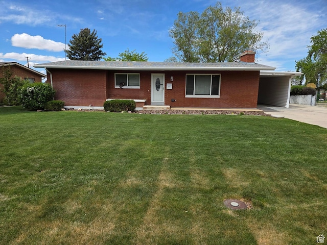 single story home with brick siding, a chimney, a front lawn, concrete driveway, and an attached carport
