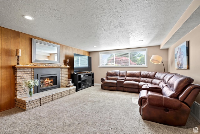 carpeted living area with a textured ceiling, a brick fireplace, and wooden walls