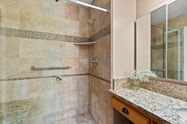 bathroom featuring a stall shower and vanity