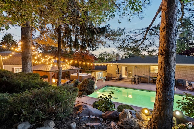 outdoor pool featuring a gazebo and a patio