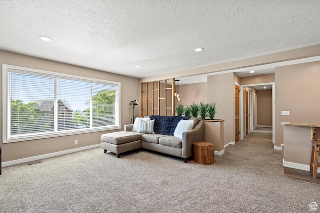 living room with carpet flooring, a textured ceiling, recessed lighting, and baseboards